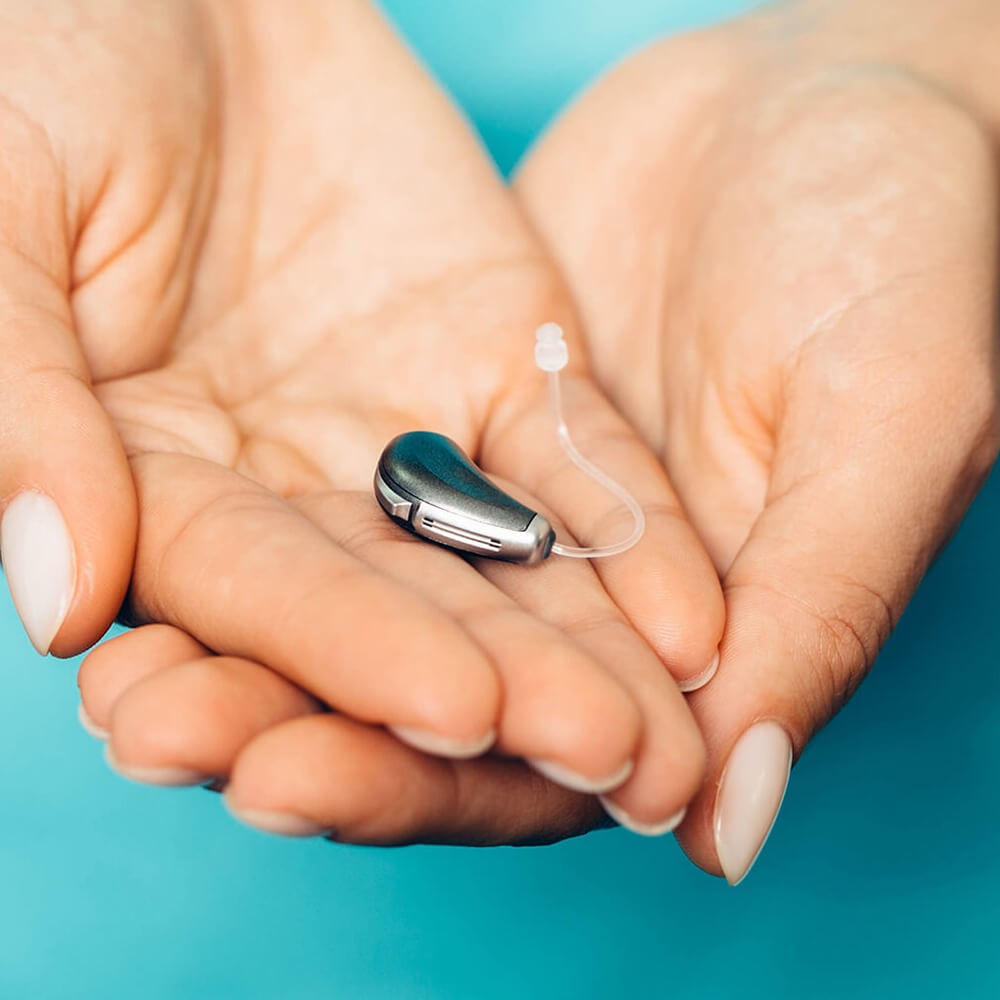 Close-up-Of-A-Doctors-Hand-Holding Hearing Aids